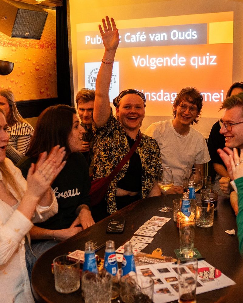 Vriendengroep aan tafel tijdens een gezellige avond bij Café van Ouds